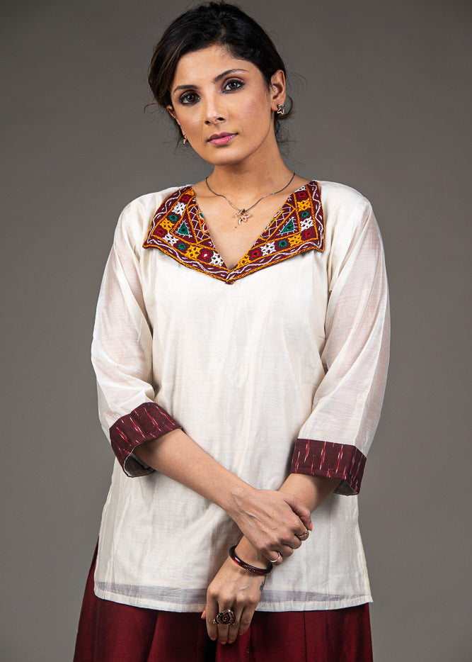 Exclusive white chanderi top with hand embroidered kutchi mirror work collar
