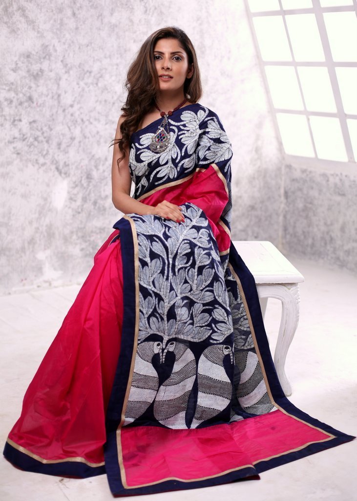 Pink chanderi saree with hand painted gond tribal art pallu and border in front