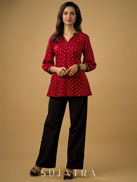 Red rayon bandhani top beautifully combined with classic ikat collar.