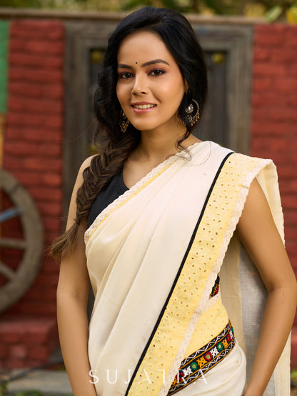 Exclusive off white mul saree with yellow hakoba border paired with Kutch mirror work border