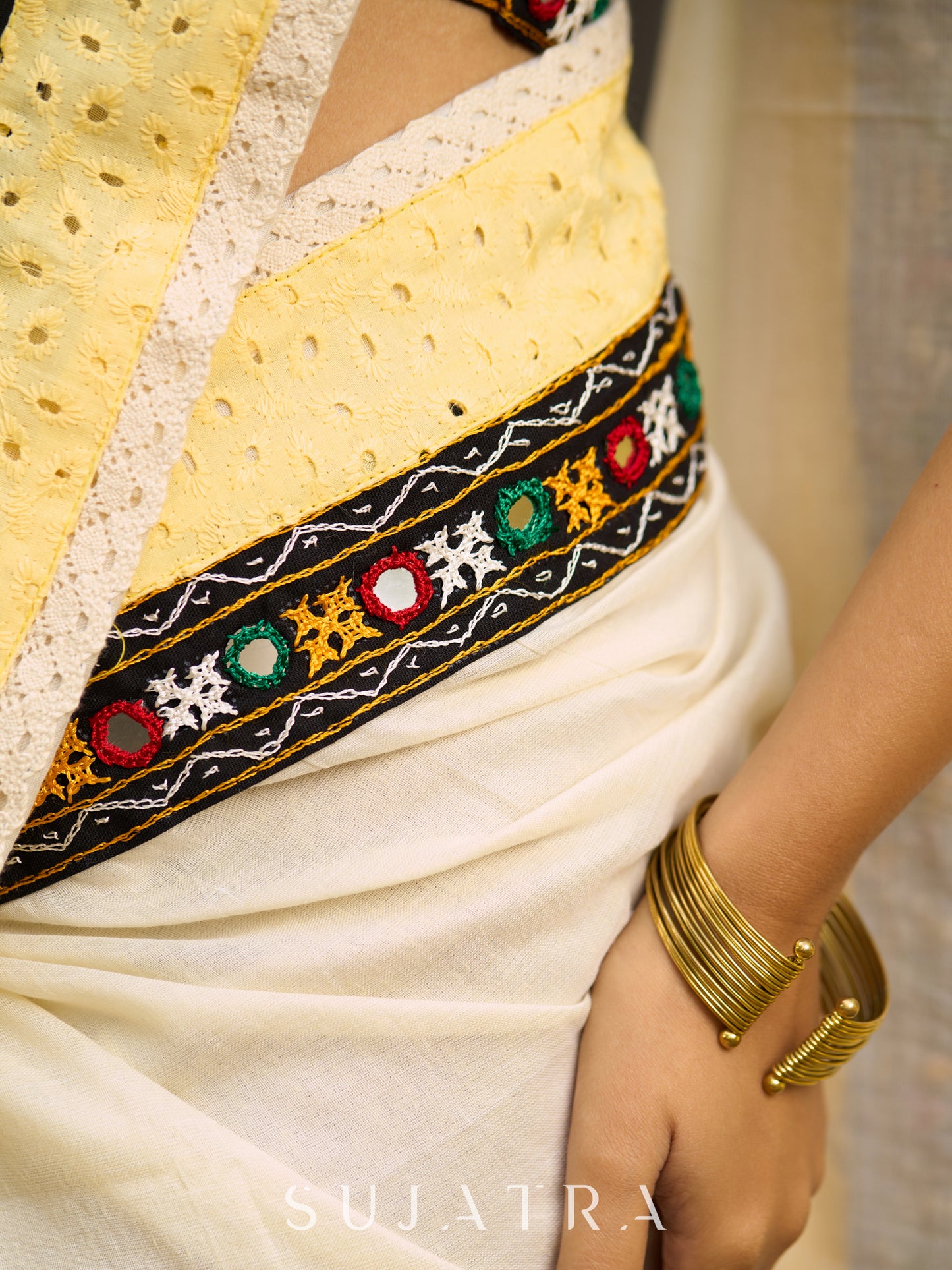 Exclusive off white mul saree with yellow hakoba border paired with Kutch mirror work border