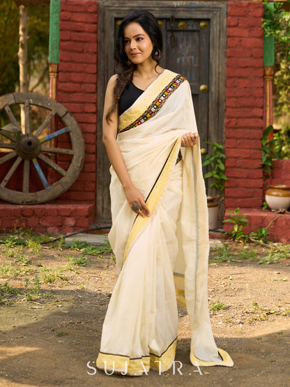 Exclusive off white mul saree with yellow hakoba border paired with Kutch mirror work border