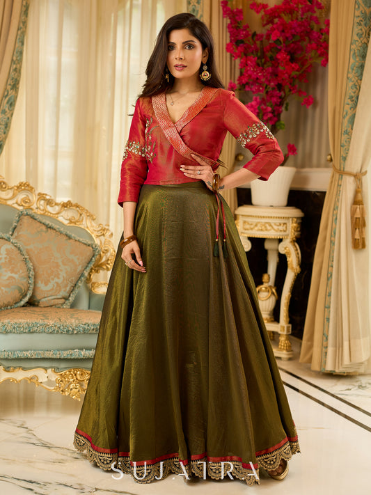 Luminous Green tissue lehenga with a classic Red Angrakha choli featuring intricate hand embroidery.