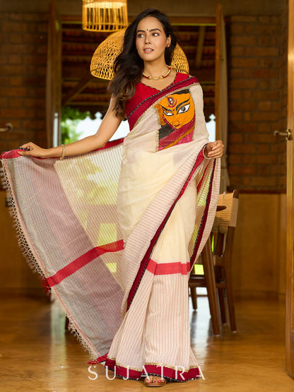 Striking white cotton saree with bold red-black borders, featuring a hand-painted Durga motif