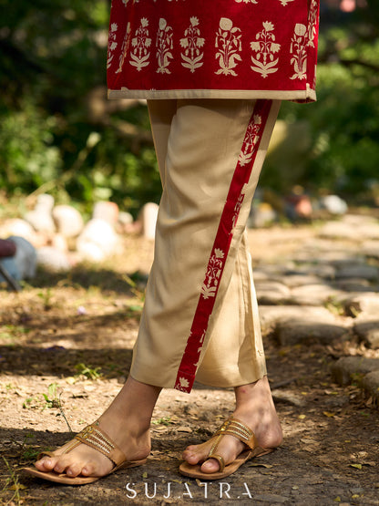 Minimal beige pants elevated with charming red floral highlights