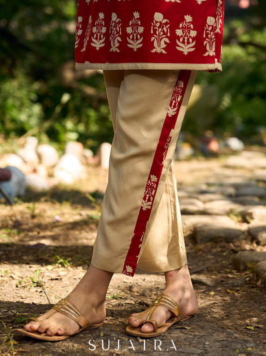 Minimal beige pants elevated with charming red floral highlights