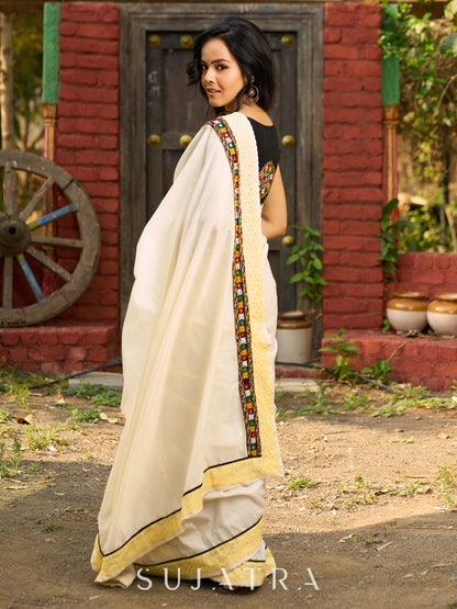 Exclusive off white mul saree with yellow hakoba border paired with Kutch mirror work border
