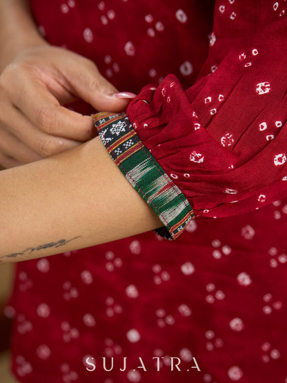 Red rayon bandhani top beautifully combined with classic ikat collar.
