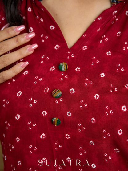 Red rayon bandhani top beautifully combined with classic ikat collar.
