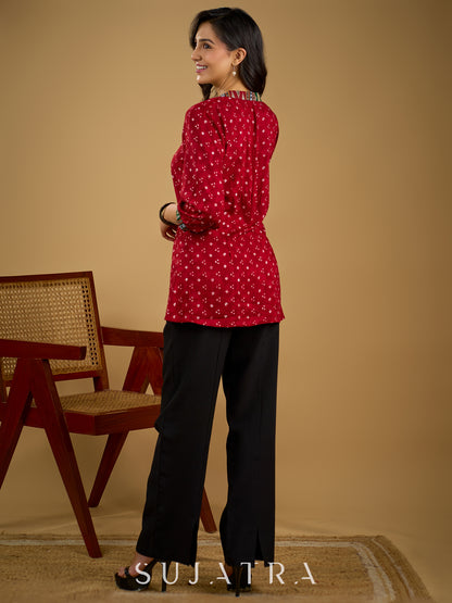 Red rayon bandhani top beautifully combined with classic ikat collar.