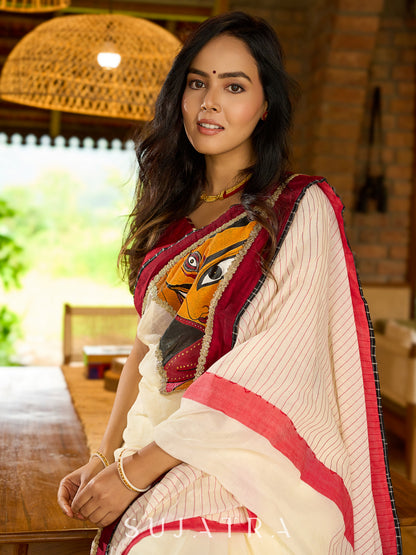 Striking white cotton saree with bold red-black borders, featuring a hand-painted Durga motif