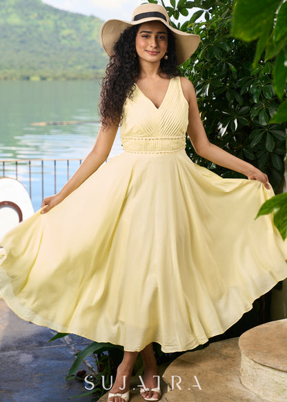 Stylish pastel yellow modal sleeveless dress highlighted with pearl embellishment on the waist.