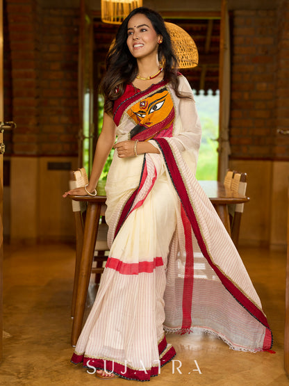 Striking white cotton saree with bold red-black borders, featuring a hand-painted Durga motif