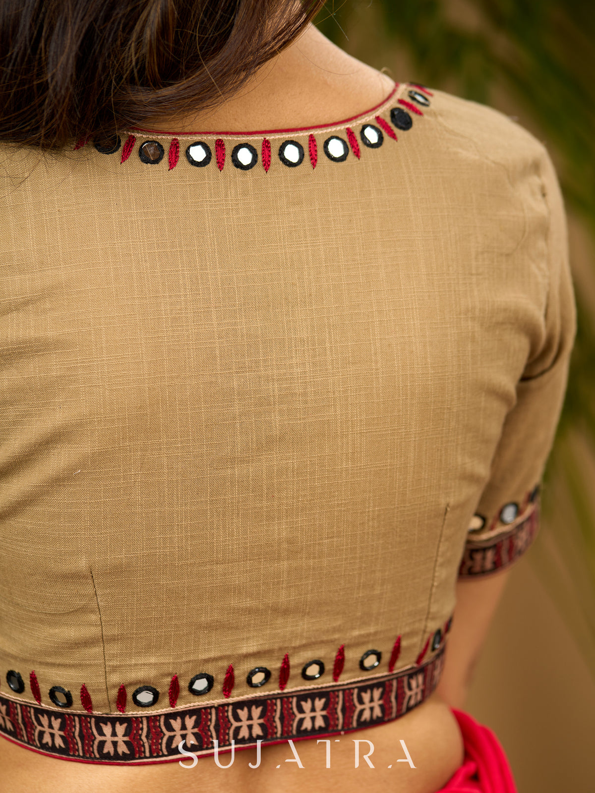 Exquisite hand embroidered dark beige ajrakh combination cotton blouse.
