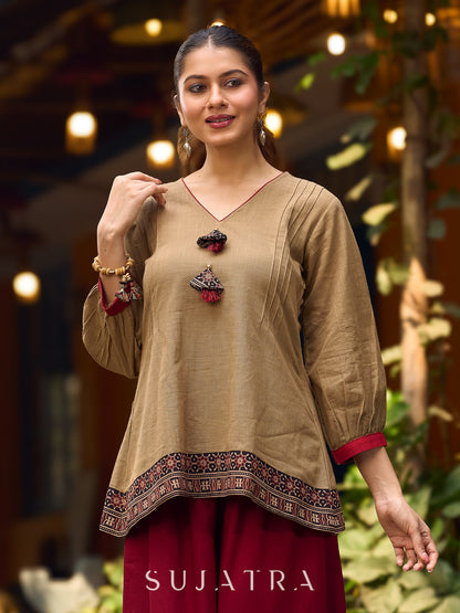 Beige Cotton Top Featuring Ajrakh Border, V Neckline, Gathered Sleeves And Fabric Tassels
