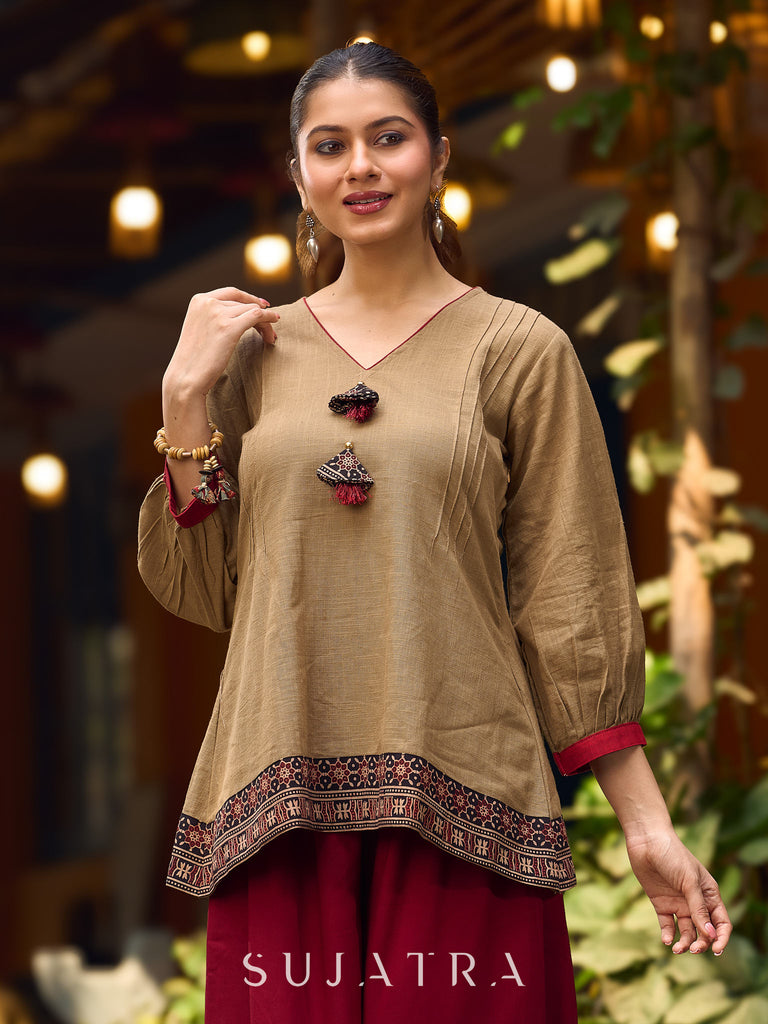 Beige Cotton Top Featuring Ajrakh Border, V Neckline, Gathered Sleeves And Fabric Tassels