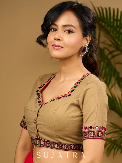 Exquisite hand embroidered dark beige ajrakh combination cotton blouse.