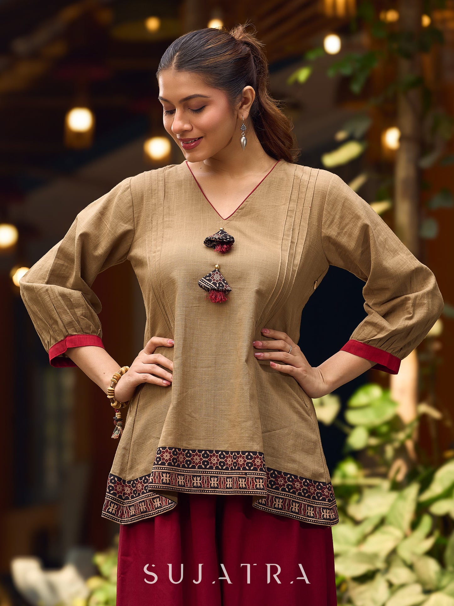 Beige Cotton Top Featuring Ajrakh Border, V Neckline, Gathered Sleeves And Fabric Tassels