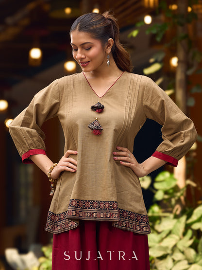 Beige Cotton Top Featuring Ajrakh Border, V Neckline, Gathered Sleeves And Fabric Tassels