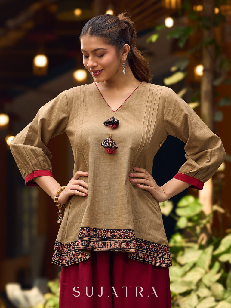 Beige Cotton Top Featuring Ajrakh Border, V Neckline, Gathered Sleeves And Fabric Tassels