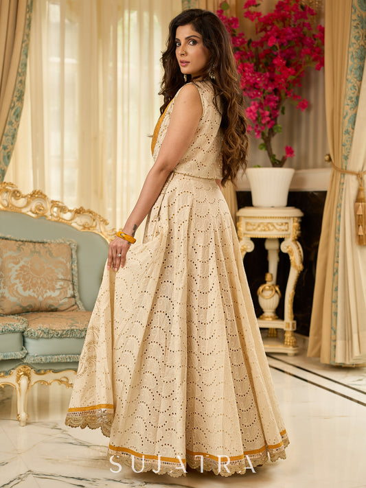 A chic off-white Hakoba Lehenga with intricate gold embroidery accented by a bold, saffron yellow blouse - Gold embroidered hakoba Shrug Optional