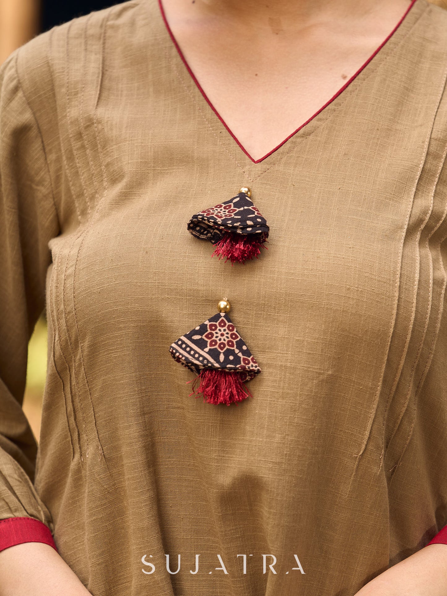 Beige Cotton Top Featuring Ajrakh Border, V Neckline, Gathered Sleeves And Fabric Tassels