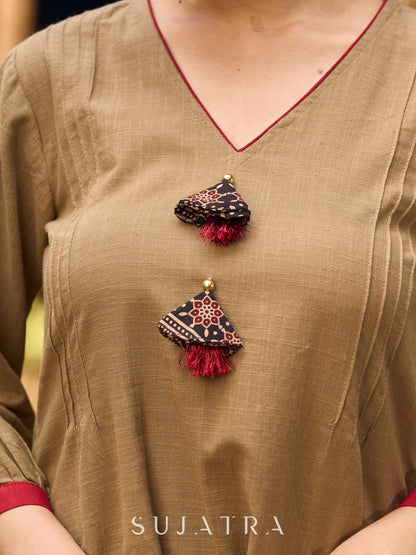 Beige Cotton Top Featuring Ajrakh Border, V Neckline, Gathered Sleeves And Fabric Tassels