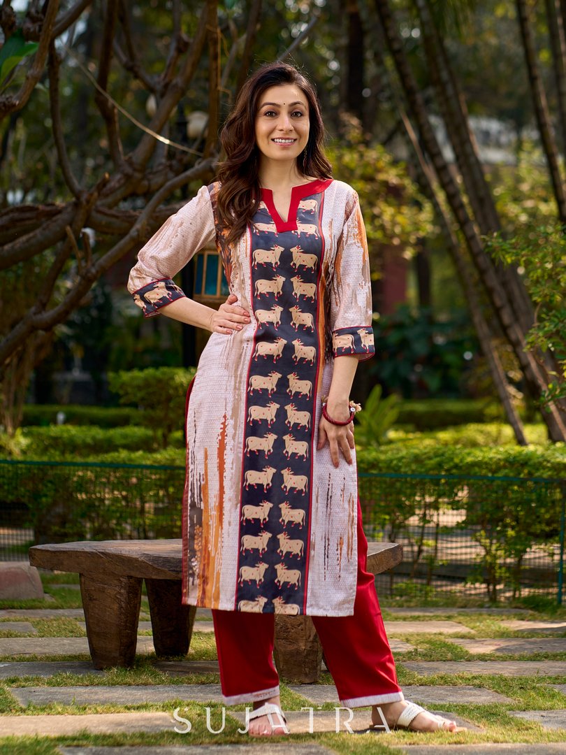 Artisanal off-white kurta showcasing Pichwai-inspired cow artwork highlighted with classic red tones