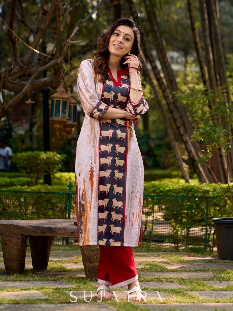 Artisanal off-white kurta showcasing Pichwai-inspired cow artwork highlighted with classic red tones