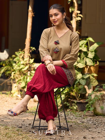 Beige Cotton Top Featuring Ajrakh Border, V Neckline, Gathered Sleeves And Fabric Tassels