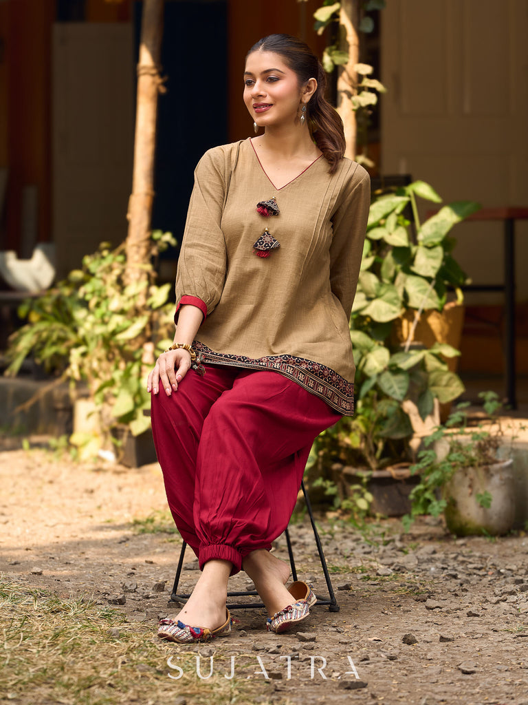 Beige Cotton Top Featuring Ajrakh Border, V Neckline, Gathered Sleeves And Fabric Tassels