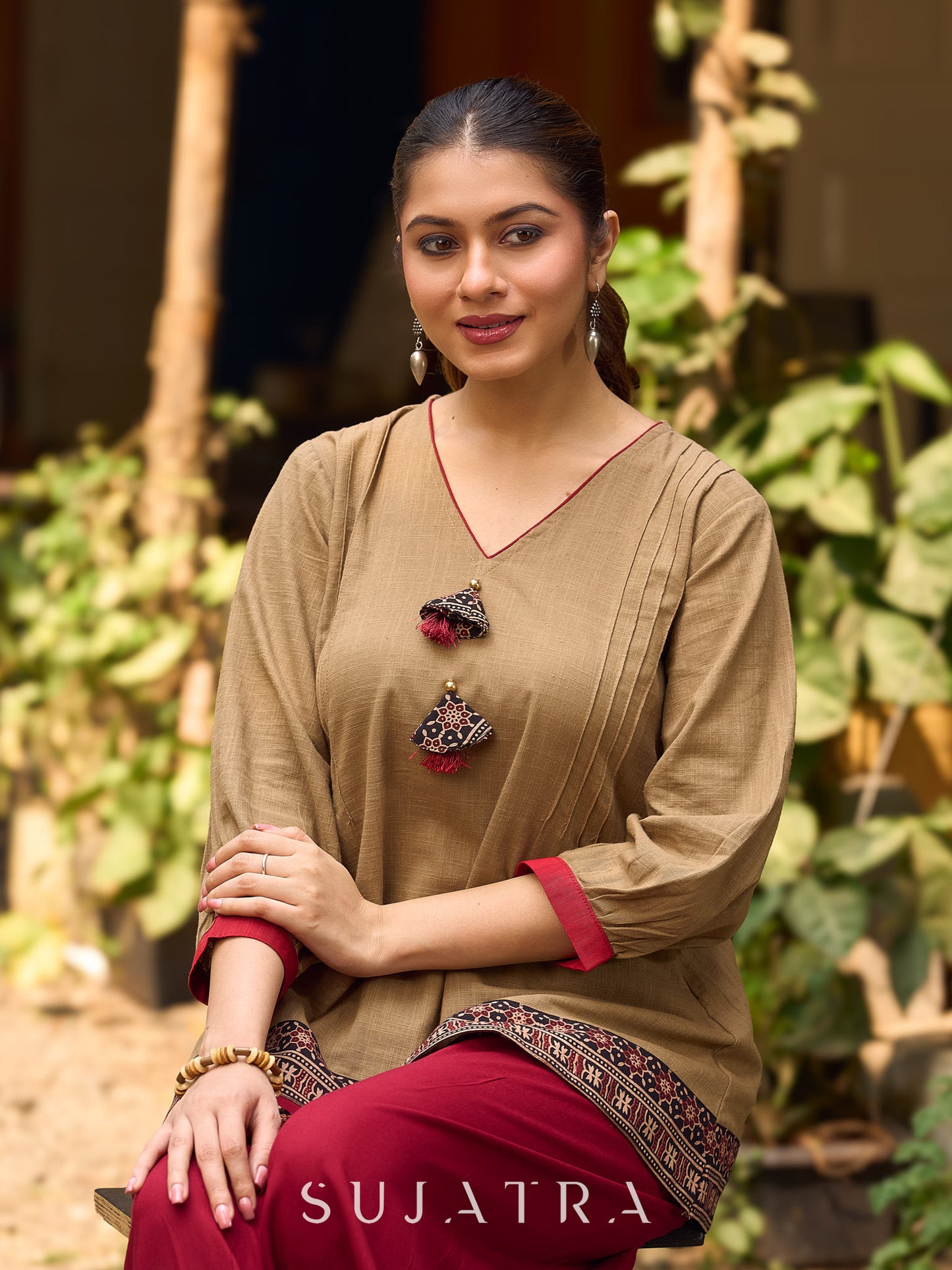 Beige Cotton Top Featuring Ajrakh Border, V Neckline, Gathered Sleeves And Fabric Tassels