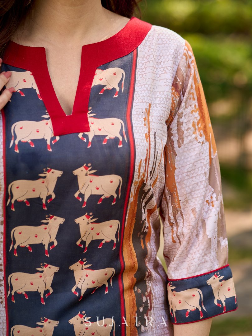 Artisanal off-white kurta showcasing Pichwai-inspired cow artwork highlighted with classic red tones