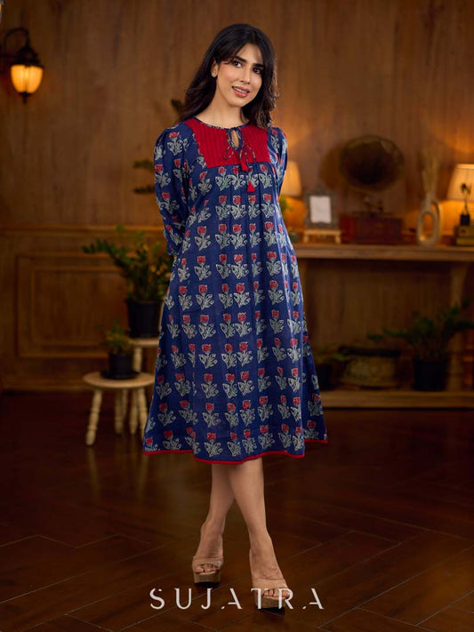 Royal blue Jaipur-printed dress featuring red rose motifs, a pintuck neck patch with red accents, and balloon 3/4th sleeves, creating a graceful silhouette with a blend of artisanal charm and contemporary elegance.