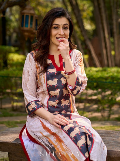 Artisanal off-white kurta showcasing Pichwai-inspired cow artwork highlighted with classic red tones