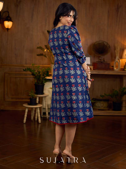 Royal blue Jaipur-printed dress featuring red rose motifs, a pintuck neck patch with red accents, and balloon 3/4th sleeves, creating a graceful silhouette with a blend of artisanal charm and contemporary elegance.