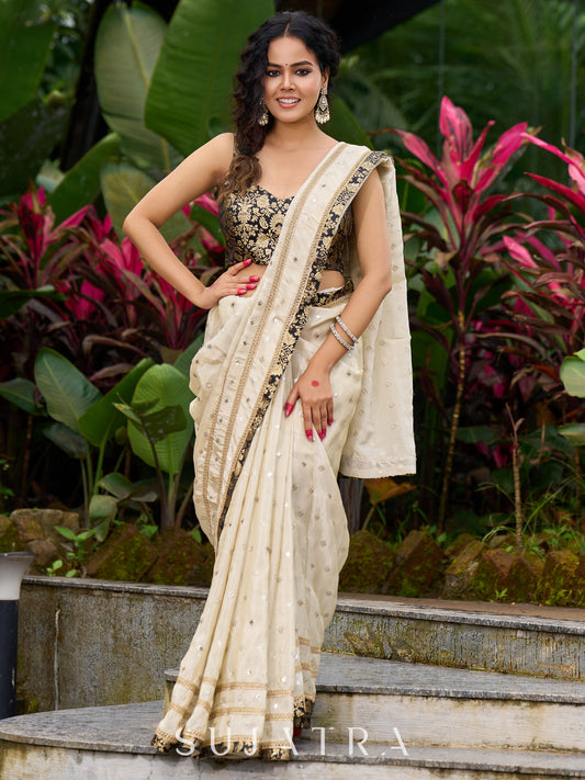 Timeless ivory tissue saree featuring zari embroidery and Banarasi accents