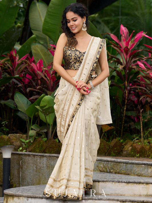 Timeless ivory tissue saree featuring zari embroidery and Banarasi accents