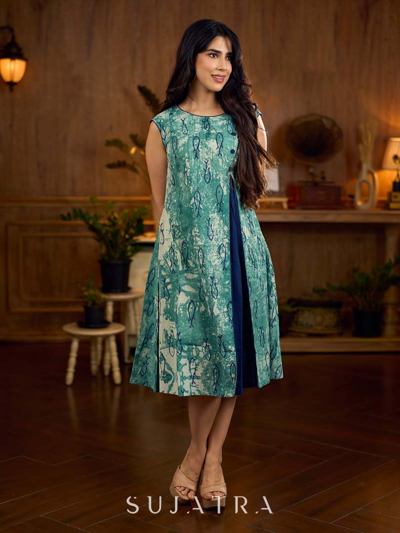 Indigo printed dress featuring playful fish motifs, designed in a gathered side-panel silhouette with contrast navy blue accents, creating a fluid, contemporary look with refined artisanal charm.
