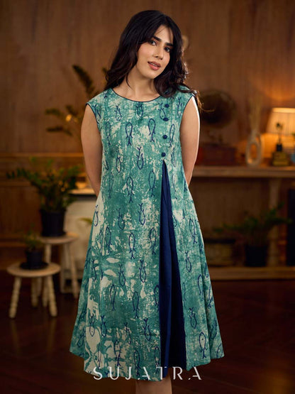 Indigo printed dress featuring playful fish motifs, designed in a gathered side-panel silhouette with contrast navy blue accents, creating a fluid, contemporary look with refined artisanal charm.