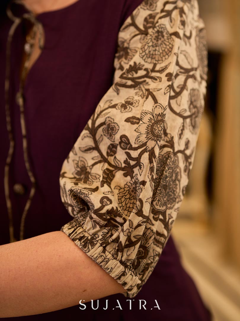 Playful purple cotton dress showcasing floral puff sleeves and box pleats released from the dart for soft volume and flow