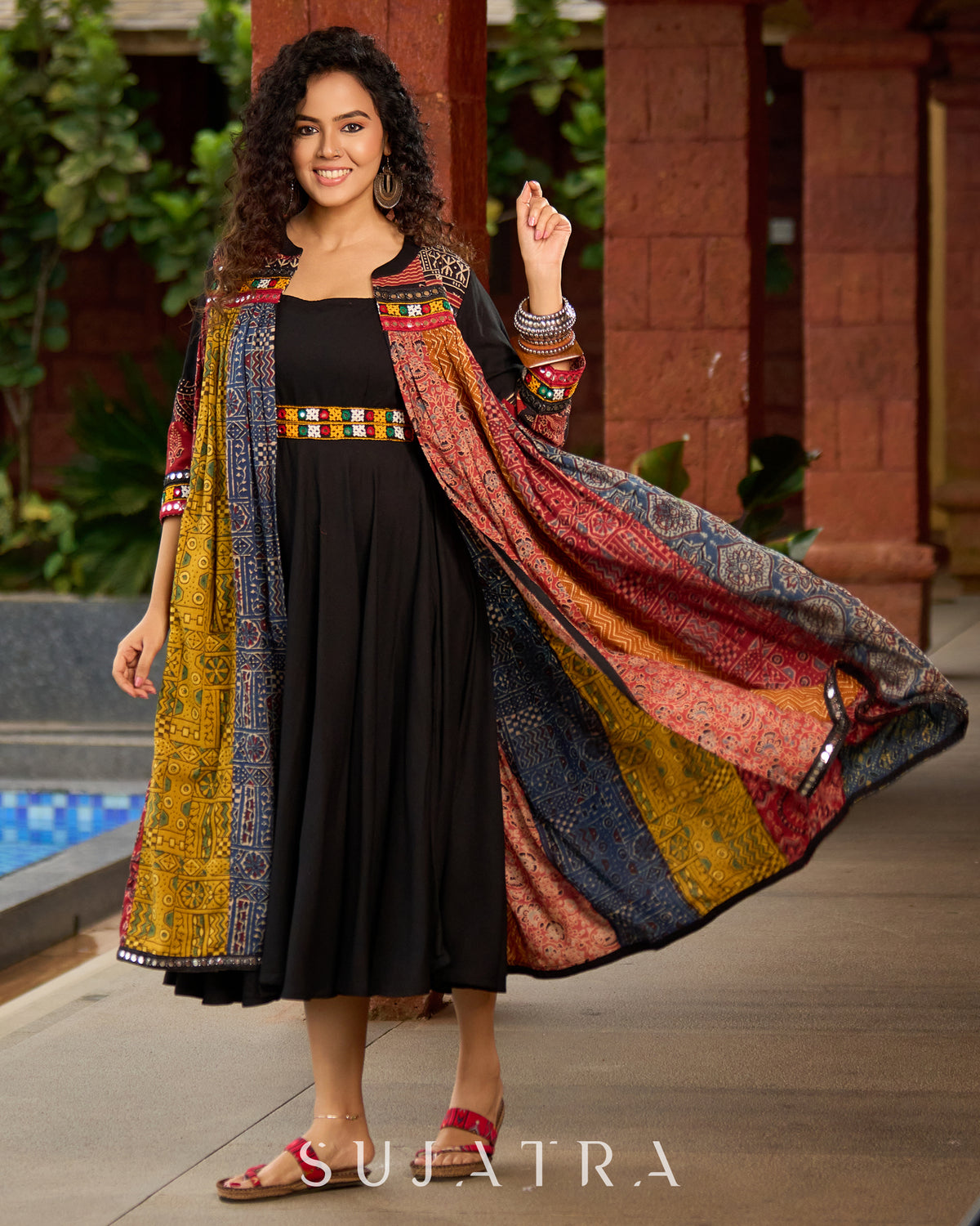 Dussehra Sale — Black Rayon Double-Flared Sleeveless Dress with Mirror Work Embellishments - Patchwork Ajrakh Jacket Optional