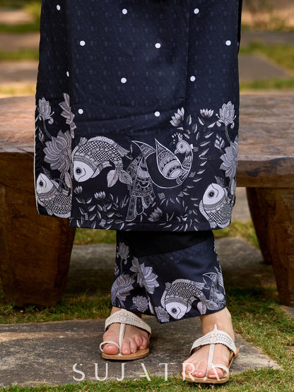 Modern black kurta blending playful polka dots and intricate Madhubani art, finished with a sleek halter neck