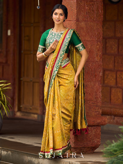 Exquisite Mustard Bandhani Print Saree with Green Benarasi Border & Tasseled Pallu with Hand Embroidered Mirror Work
