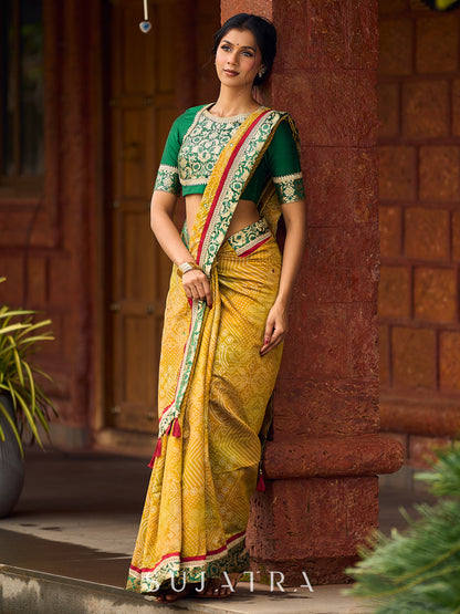 Exquisite Mustard Bandhani Print Saree with Green Benarasi Border & Tasseled Pallu with Hand Embroidered Mirror Work