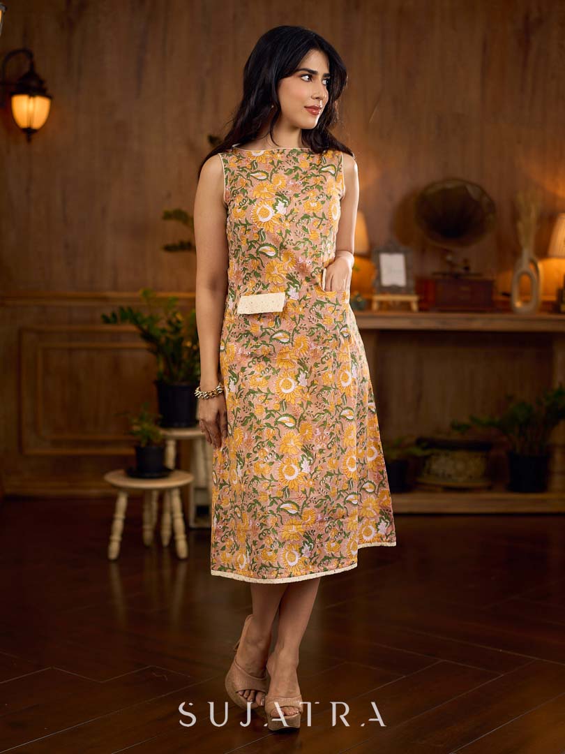Summery mustard and peach floral sleeveless dress featuring a boat neckline and Hakoba pocket detailing, finished with soft off-white accents for a breezy, cheerful silhouette perfect for warm days.