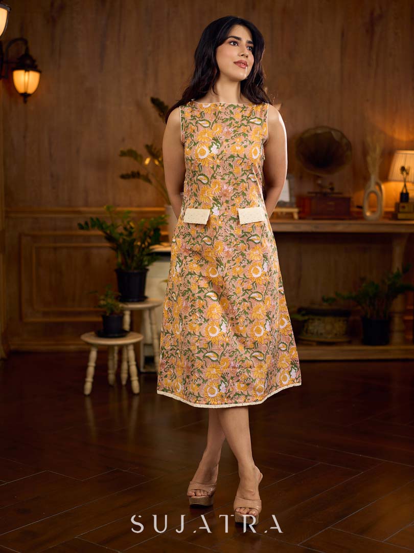 Summery mustard and peach floral sleeveless dress featuring a boat neckline and Hakoba pocket detailing, finished with soft off-white accents for a breezy, cheerful silhouette perfect for warm days.