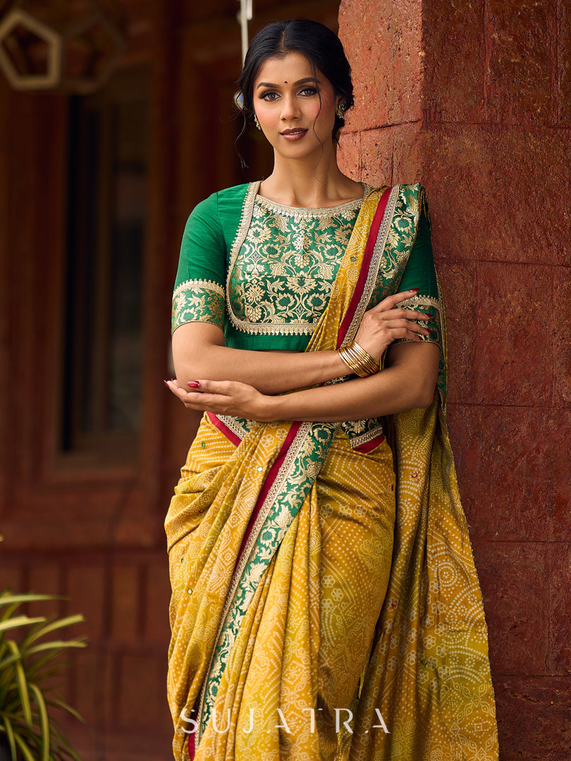 Exquisite Mustard Bandhani Print Saree with Green Benarasi Border & Tasseled Pallu with Hand Embroidered Mirror Work