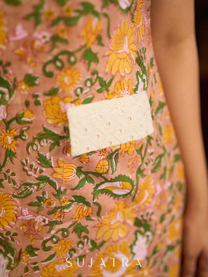 Summery mustard and peach floral sleeveless dress featuring a boat neckline and Hakoba pocket detailing, finished with soft off-white accents for a breezy, cheerful silhouette perfect for warm days.