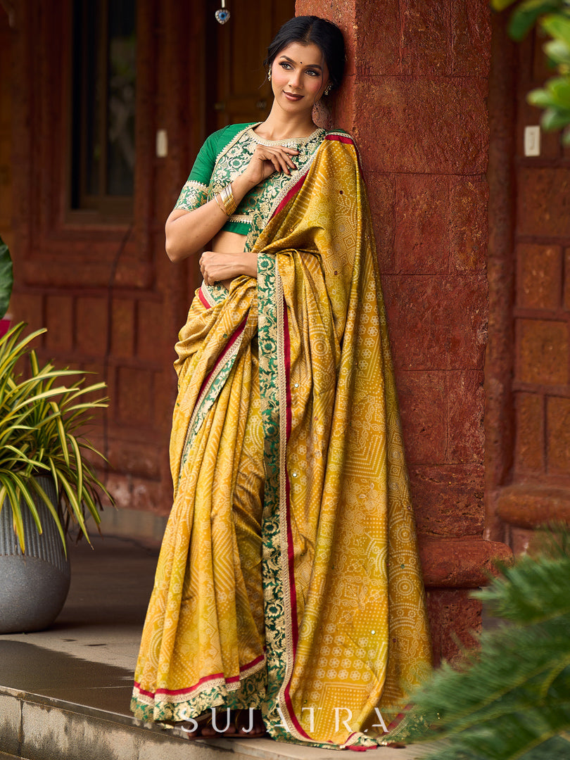 Exquisite Mustard Bandhani Print Saree with Green Benarasi Border & Tasseled Pallu with Hand Embroidered Mirror Work